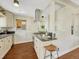 Bright kitchen with granite countertops, stainless steel appliances, and modern vent hood at 732 Poplar St, Denver, CO 80220