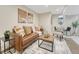 Comfortable living room with neutral walls, leather sofa, and bright overhead lighting at 732 Poplar St, Denver, CO 80220