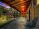 Enclosed patio with wooden beam roofing and stone fireplace with chairs at 732 Poplar St, Denver, CO 80220