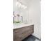 Modern bathroom boasts double vanity and sleek wood cabinets at 6435 E 6Th Avenue Pkwy, Denver, CO 80220