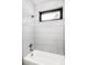 Clean bathroom with a shower/tub combo and subway tile at 6435 E 6Th Avenue Pkwy, Denver, CO 80220