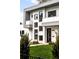 Modern two-story home with gray and white exterior, balcony, and manicured lawn at 6435 E 6Th Avenue Pkwy, Denver, CO 80220