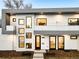 Modern home's exterior, showcasing gray and white design, balcony, and nighttime lighting at 6435 E 6Th Avenue Pkwy, Denver, CO 80220