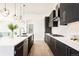 Modern kitchen with dark cabinetry and white quartz countertops at 6435 E 6Th Avenue Pkwy, Denver, CO 80220