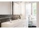 Stylish bathroom with double sinks, modern fixtures, and a view into the bedroom, offers a spa-like experience at 1810 E 33Rd Ave, Denver, CO 80205