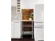 Cozy kitchen area featuring a wooden shelf with a plant and adjacent white refrigerator at 1810 E 33Rd Ave, Denver, CO 80205