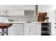 Modern kitchen with white cabinets, quartz countertop, and tiled backsplash at 1810 E 33Rd Ave, Denver, CO 80205