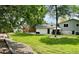 A large backyard with well-maintained lawn, a shed, with patio seating area at 5389 W Roxbury Pl, Littleton, CO 80128