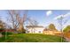 Expansive backyard featuring lush lawn, tall trees, and a privacy fence at 5389 W Roxbury Pl, Littleton, CO 80128