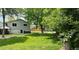 Large grassy backyard with a hot tub and fence perimeter for privacy at 5389 W Roxbury Pl, Littleton, CO 80128