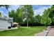 Large backyard featuring a well-maintained lawn, mature trees, and a patio area perfect for outdoor entertaining at 5389 W Roxbury Pl, Littleton, CO 80128