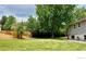 Beautiful backyard with a well-manicured lawn, tall trees, and a wooden fence at 5389 W Roxbury Pl, Littleton, CO 80128