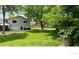 Large, well-maintained backyard with lush lawn, mature trees, and hot tub at 5389 W Roxbury Pl, Littleton, CO 80128