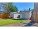 Backyard sheds surrounded by grass and gravel at 5389 W Roxbury Pl, Littleton, CO 80128