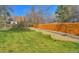 Manicured backyard with lush green lawn, wood fence, and a well-maintained landscape at 5389 W Roxbury Pl, Littleton, CO 80128