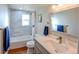 Bright bathroom featuring a shower/tub with tile surround and a modern vanity at 5389 W Roxbury Pl, Littleton, CO 80128