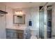 Beautiful bathroom with white marble tile, a large mirror and a glass shower at 5389 W Roxbury Pl, Littleton, CO 80128