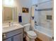 Bright bathroom featuring a shower/tub with white tile surround and a modern vanity at 5389 W Roxbury Pl, Littleton, CO 80128