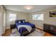 Bedroom featuring hardwood floors, two windows, a queen bed and neutral paint at 5389 W Roxbury Pl, Littleton, CO 80128