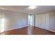 Neutral bedroom with wood-look flooring and a double door closet at 5389 W Roxbury Pl, Littleton, CO 80128