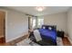 Bright bedroom with hardwood floors, and a sliding door to the ensuite bathroom at 5389 W Roxbury Pl, Littleton, CO 80128