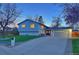 Charming home exterior featuring a well-maintained lawn, a two-car garage, and mature trees at 5389 W Roxbury Pl, Littleton, CO 80128