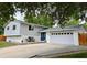 Two story home with a driveway leading up to a two car garage and a blue door at 5389 W Roxbury Pl, Littleton, CO 80128