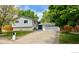 Charming two-story home with a well-manicured lawn, a driveway, and a two car garage at 5389 W Roxbury Pl, Littleton, CO 80128