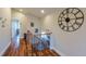 Hallway featuring wood floors, wood railings and a large clock on the wall at 5389 W Roxbury Pl, Littleton, CO 80128
