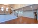 Open concept living room with hardwood floors, staircase and bright natural light at 5389 W Roxbury Pl, Littleton, CO 80128
