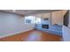 Cozy living room features a brick fireplace, hardwood floors, and a large window providing natural light at 5389 W Roxbury Pl, Littleton, CO 80128