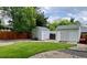 Two storage sheds in a fenced back yard feature landscaping with gravel and greenery at 5389 W Roxbury Pl, Littleton, CO 80128