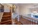 Well-lit staircase featuring hardwood steps and decorative wrought iron railings at 5389 W Roxbury Pl, Littleton, CO 80128