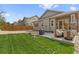 Private backyard with patio and grassy area at 6484 S Harvest St, Aurora, CO 80016