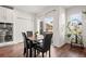 Cozy dining area with four chairs and sliding glass doors to backyard at 6484 S Harvest St, Aurora, CO 80016