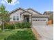 Charming single-story home boasts stone accents, a two-car garage, and a well-manicured lawn at 6484 S Harvest St, Aurora, CO 80016