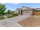 Ranch style home with a large driveway and landscaped front yard at 6484 S Harvest St, Aurora, CO 80016