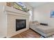 Living room fireplace with light colored stone and modern mantel at 6484 S Harvest St, Aurora, CO 80016