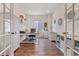 Bright home office with built-in shelving and French doors at 6484 S Harvest St, Aurora, CO 80016