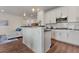 Open kitchen with a breakfast bar and stainless steel appliances at 6484 S Harvest St, Aurora, CO 80016