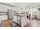 Modern kitchen with white cabinets, stainless steel appliances, and an island at 6484 S Harvest St, Aurora, CO 80016