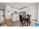 Modern kitchen with island, stainless steel appliances, and hardwood floors at 6484 S Harvest St, Aurora, CO 80016