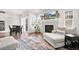 Living area features fireplace, hardwood floors, and a large TV at 6484 S Harvest St, Aurora, CO 80016