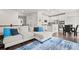 Bright living room features a comfortable sectional sofa and opens to the kitchen at 6484 S Harvest St, Aurora, CO 80016
