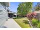 Spacious backyard with lush lawn, mature trees, and a covered patio, perfect for outdoor activities at 12218 Monroe Dr, Thornton, CO 80241