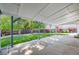 Covered patio overlooking a well-maintained backyard with lush green grass and mature trees at 12218 Monroe Dr, Thornton, CO 80241