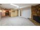 Finished basement with fireplace, carpet flooring, and wet bar at 12218 Monroe Dr, Thornton, CO 80241