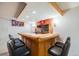Finished basement featuring a wet bar with seating, wood paneled accents, and recessed lighting at 12218 Monroe Dr, Thornton, CO 80241