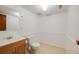 Bathroom features a wooden vanity with a tiled floor, a toilet and neutral wall color, providing a clean and functional space at 12218 Monroe Dr, Thornton, CO 80241
