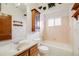 Bathroom featuring a single sink vanity, bathtub, and decorative shelving at 12218 Monroe Dr, Thornton, CO 80241